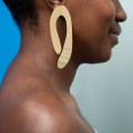 Asymmetrical, shiny gold earrings from the Tache collection