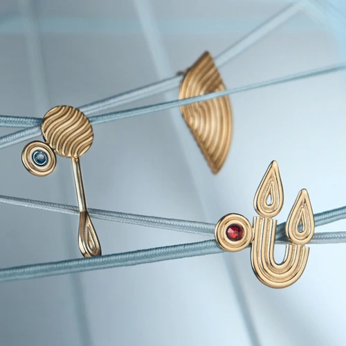 Goldplated pins with symbols of the elements