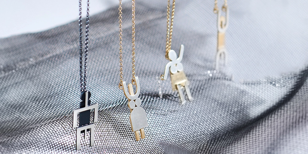 Silver robot shaped necklaces by ORSKA jewelry