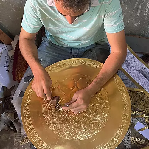 Moroccan craftsman making a lamp