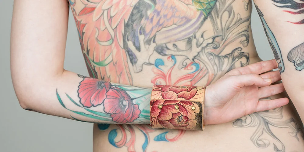 Bracelet with a multicolor tattoo of a peony