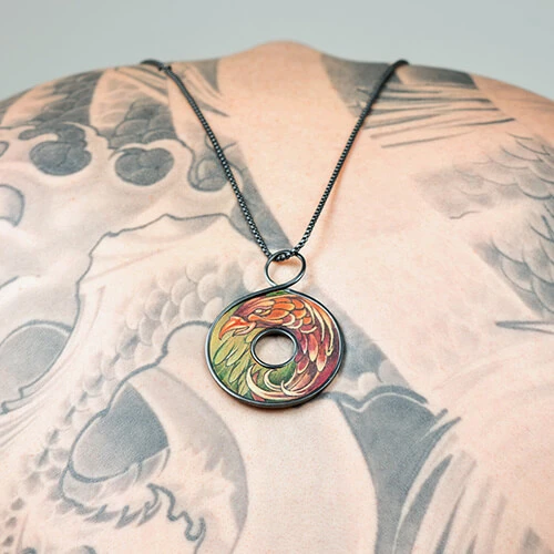 Necklace with a multicolor pheonix tattoo